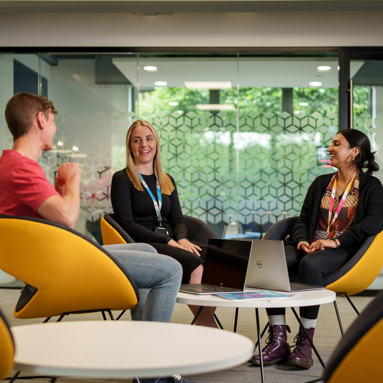 Three employees having casual meeting