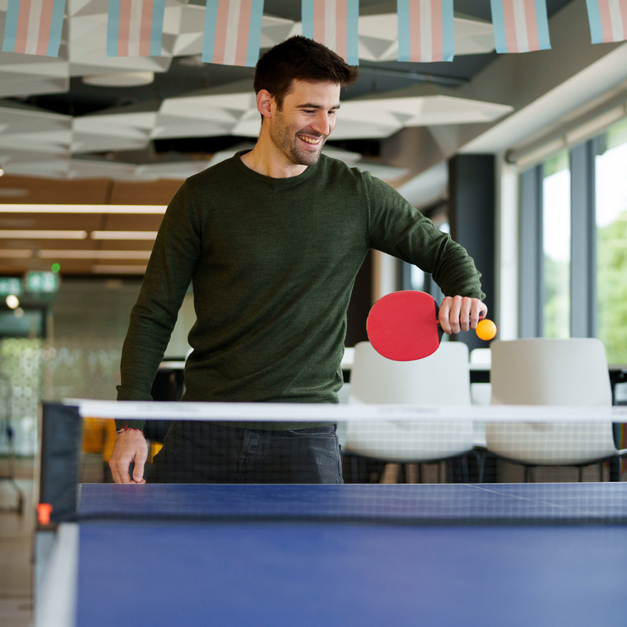 Employee playing table tennis in LCP Winchester office